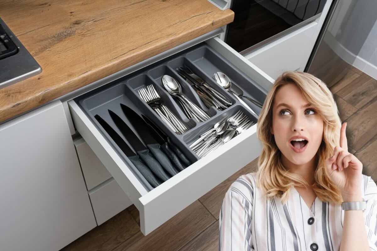 Donna che si pone una domanda e cassetto delle posate in cucina